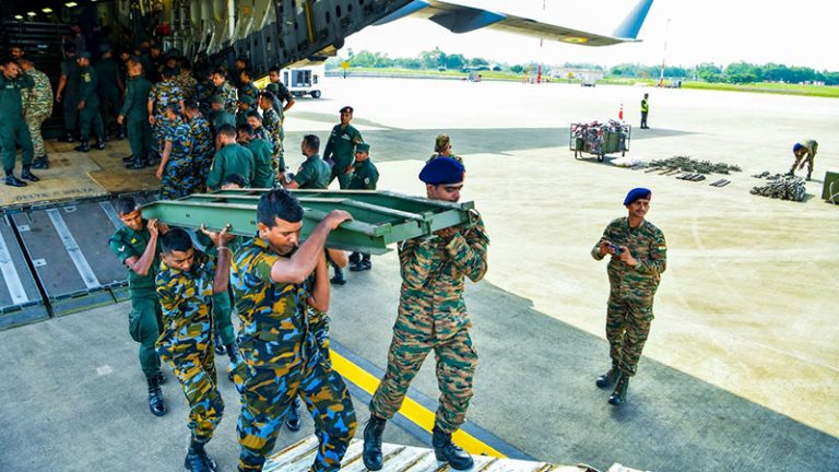 Sri Lankan and Indian Air Force personnel unloading Bailey bridge components in Sri Lanka for disaster relief
