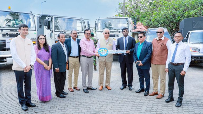 Handing over a symbolic key to Minister Sunil Handunnetti, with India’s High Commissioner Santosh Jha and other officials present
