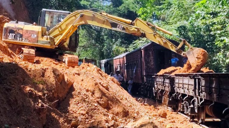 Railway workers repairing a damaged railway line in Sri Lanka after heavy weather