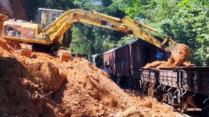Railway workers repairing a damaged railway line in Sri Lanka after heavy weather