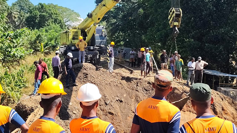Railway workers repairing a damaged railway line in Sri Lanka after heavy weather