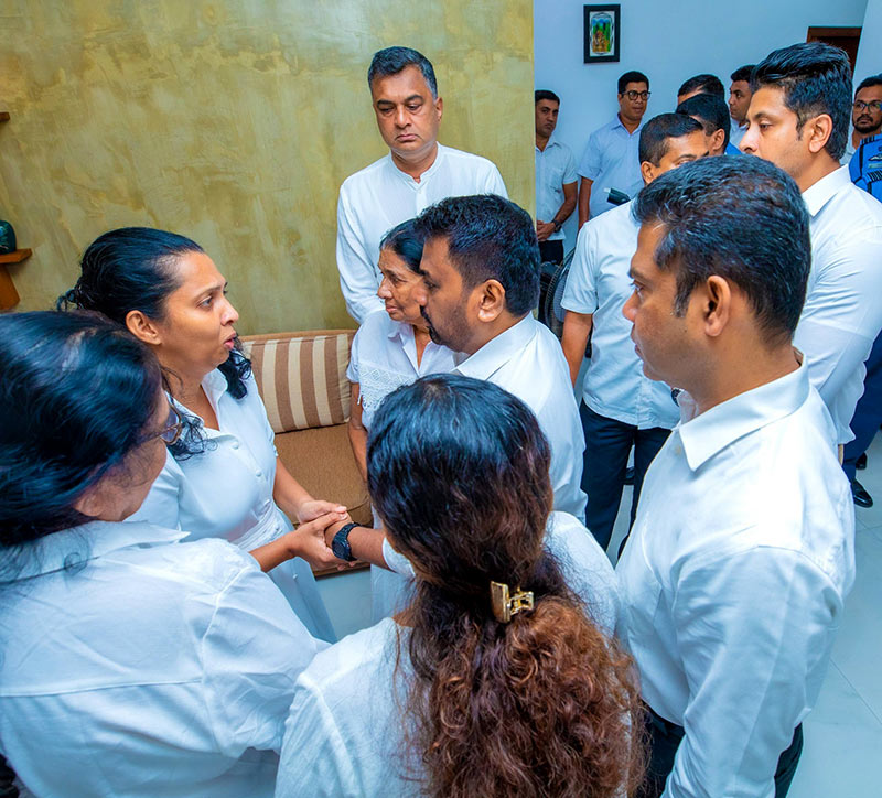 Sri Lanka President Anura Kumara Dissanayake speaking with Group Captain Nirmal Siyambalapitiya’s wife after offering his respects