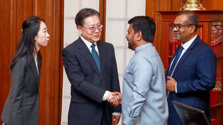 Chinese Vice Chairman Wang Dongming shakes hands with Sri Lankan President Anura Kumara Dissanayake during an official meeting in Colombo following Cyclone Ditwah