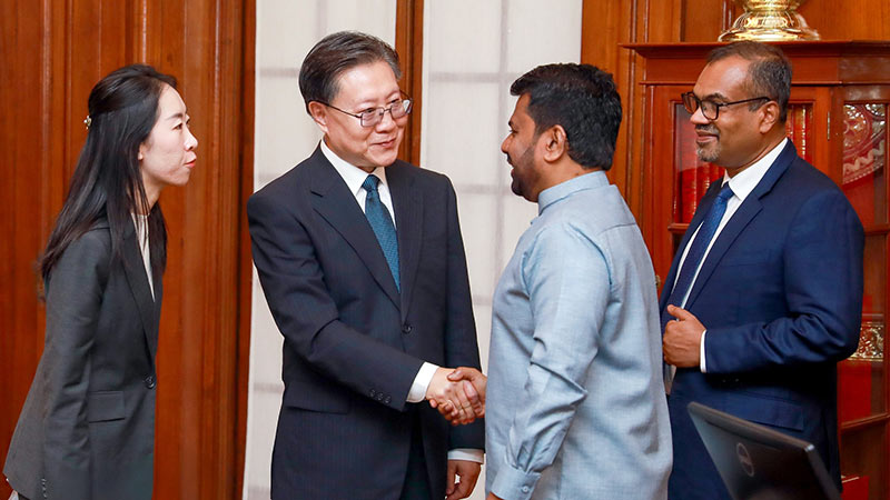 Chinese Vice Chairman Wang Dongming shakes hands with Sri Lankan President Anura Kumara Dissanayake during an official meeting in Colombo following Cyclone Ditwah