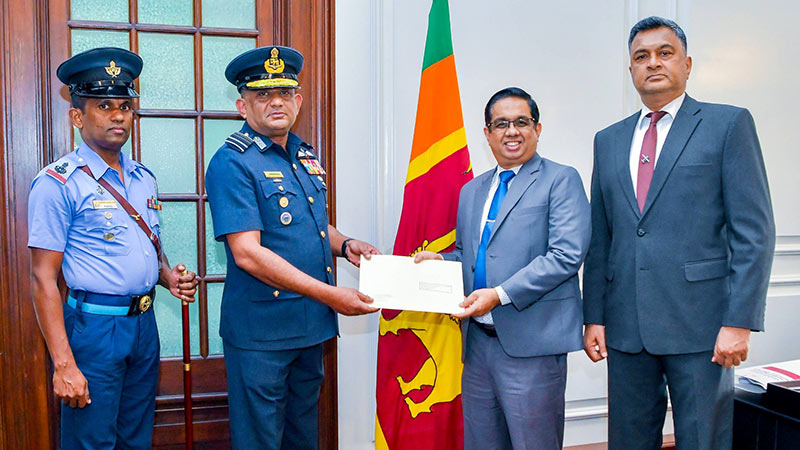 Sri Lanka Air Force Commander Air Marshal Vasu Bandu Edirisinghe handing over cheque to Secretary to the President Dr. Nandika Sanath Kumanayake