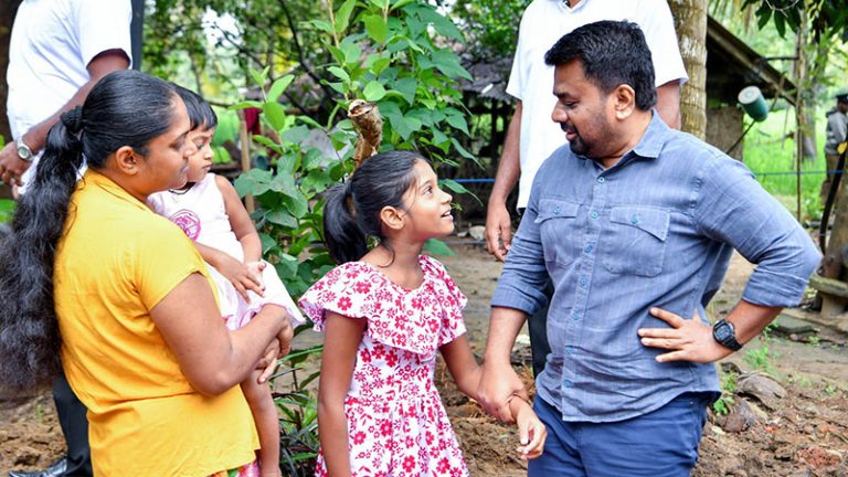 Sri Lanka President Anura Kumara Dissanayake speaks with a villager during a community visit