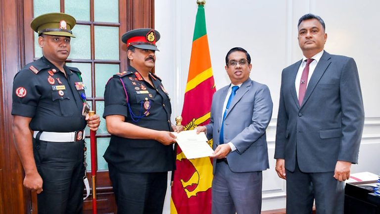 Sri Lanka Army Commander Major General Lasantha Rodrigo handing over cheque to Secretary to the President Dr. Nandika Sanath Kumanayake