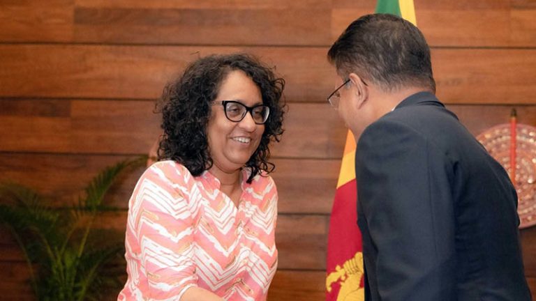 Sri Lanka Prime Minister Dr. Harini Amarasuriya and Dialog Axiata Group CEO Supun Weerasinghe shaking hands during the LKR 420 million Rebuilding Sri Lanka commitment
