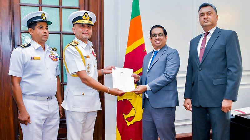 Sri Lanka Navy Commander Rear Admiral Kanchana Banagoda handing over cheque to Secretary to the President Dr. Nandika Sanath Kumanayake
