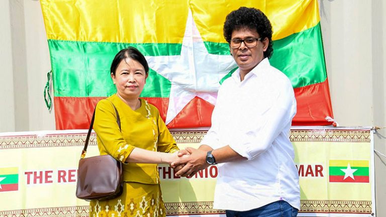 Myanmar Ambassador to Sri Lanka Marlar Than Htaik shakes hands with Minister of Trade, Commerce, Food Security and Cooperative Development, Wasantha Samarasinghe during rice donation handover at Colombo Port
