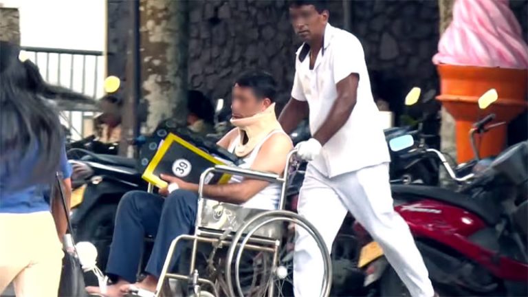 An Iranian sailor using a wheelchair moves through a corridor at Karapitiya Hospital in Galle, Sri Lanka
