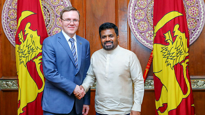 Russian Deputy Minister of Energy Roman Marshavin shakes hands with Sri Lanka President Anura Kumara Dissanayake during an official meeting in Colombo