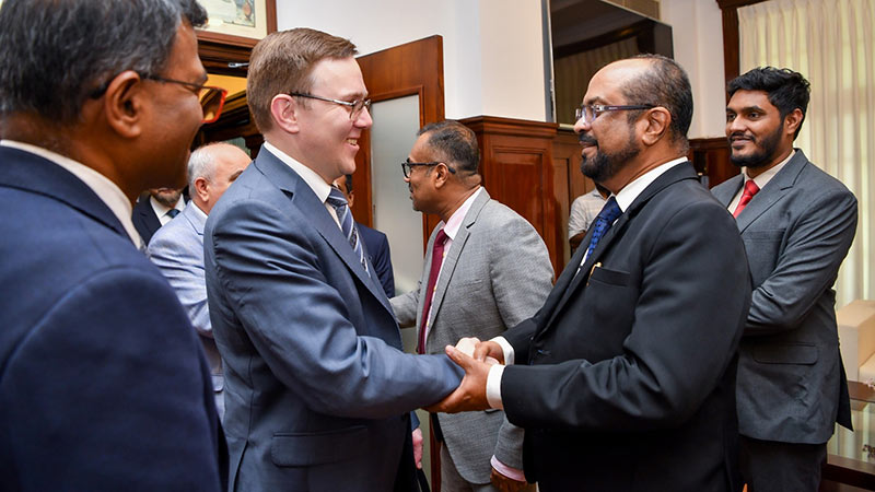 Russia’s Deputy Energy Minister Roman Marshavin shakes hands with Sri Lanka’s Energy Minister Kumara Jayakody
