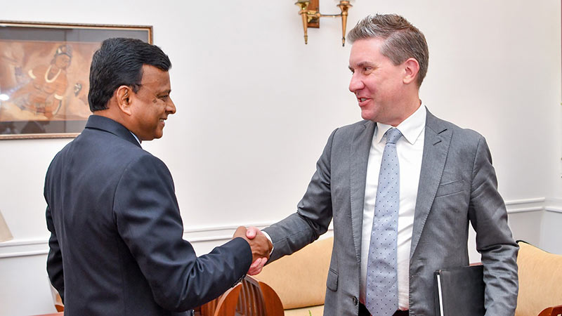 Anthony V. Pirnot shakes hands with Prabath Chandrakeerthi during talks at the Presidential Secretariat in Colombo