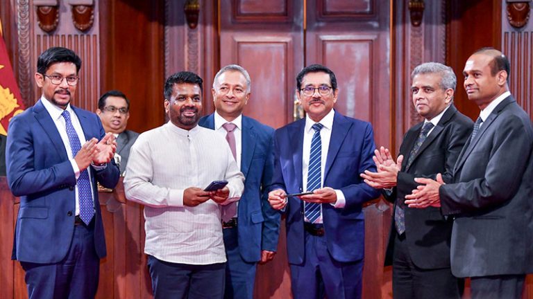Sri Lanka President Anura Kumara Dissanayake uses LankaQR during the launch of Sri Lanka’s National QR Payment Adoption Programme as Central Bank Governor Dr. Nandalal Weerasinghe and Deputy Minister Eranga Weeraratne look on in Colombo