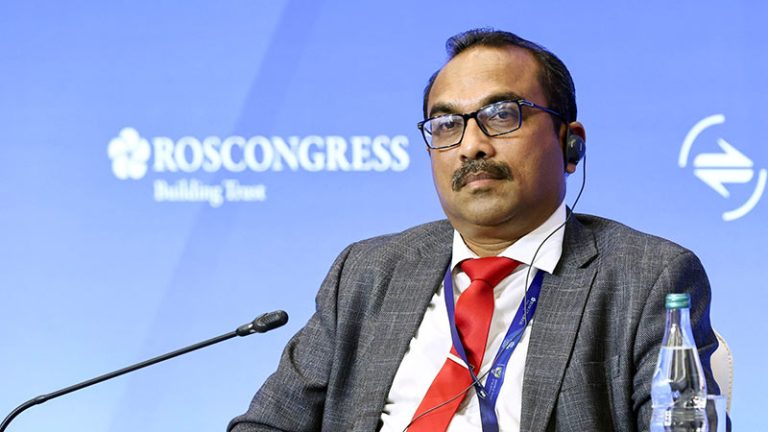 Sri Lankan Minister Bimal Rathnayake listens to speeches through headphones at the International Transport and Logistics Forum in Saint Petersburg, Russia