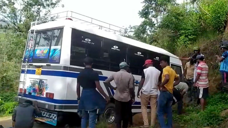 School bus after accident on Ranikadu-Bogawantalawa road with people gathered near the scene