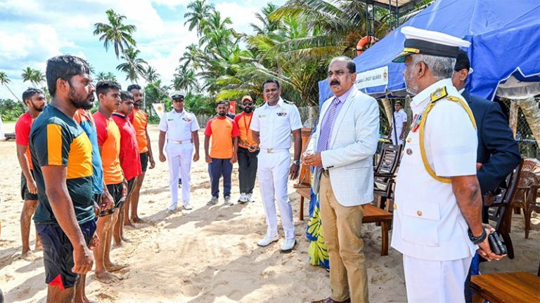 Deputy Defence Minister Aruna Jayasekara speaks with Coast Guard officials during a beach visit