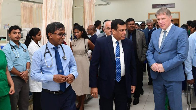 Russian Health Minister Mikhail Murashko speaks with doctors during a visit to a ward at Colombo National Hospital in Sri Lanka