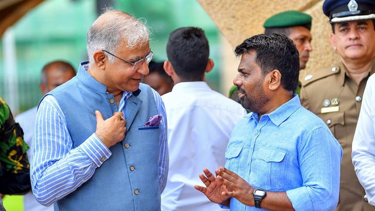Indian High Commissioner Santosh Jha speaking with Sri Lankan President Anura Kumara Dissanayake during the vehicle handover event