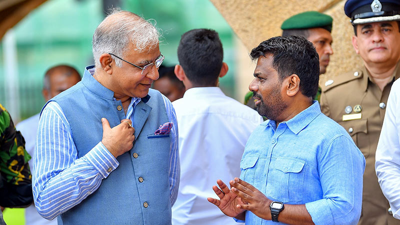 Indian High Commissioner Santosh Jha speaking with Sri Lankan President Anura Kumara Dissanayake during the vehicle handover event