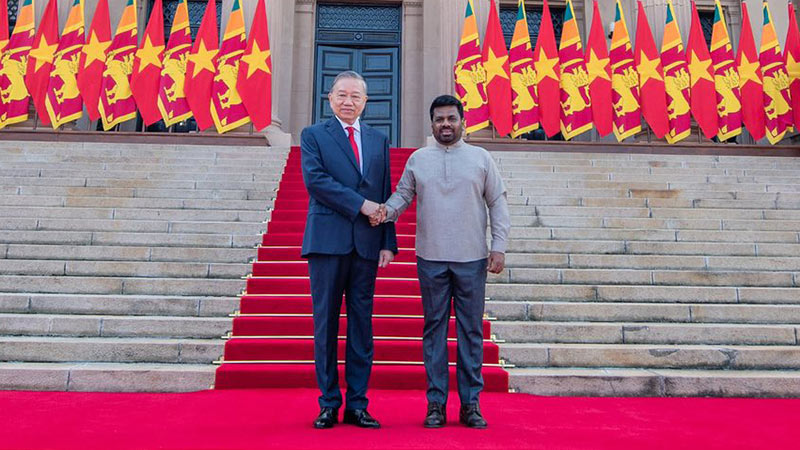 Vietnamese President To Lam and Sri Lankan President Anura Kumara Dissanayake shake hands at the Presidential Secretariat in Colombo
