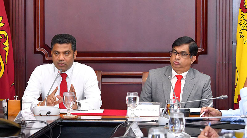 Health Minister Dr. Nalinda Jayatissa speaks during a dengue control meeting at the Presidential Secretariat as Secretary to the President Dr. Nandika Sanath Kumanayake looks on