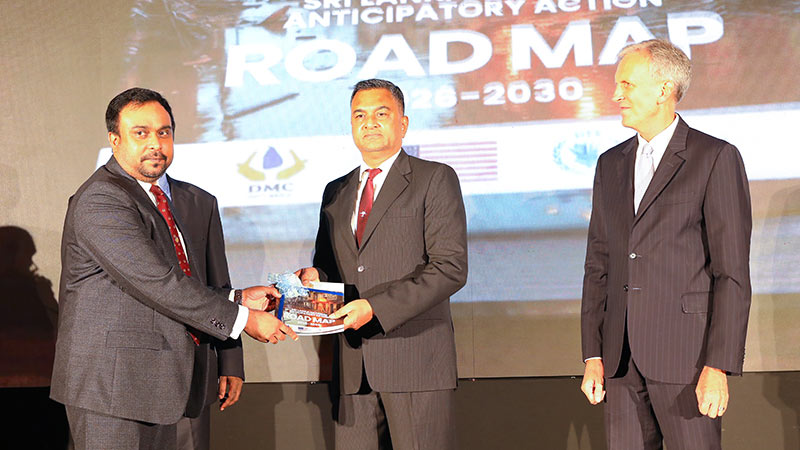 Defence Secretary Air Vice Marshal (Retd) Sampath Thuyacontha receives the first copy of the Sri Lanka National Anticipatory Action Roadmap 2026-2030 at its launch in Colombo on June 4, 2026