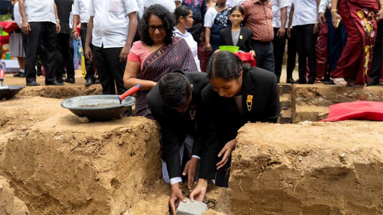 Two students lay the foundation stone for a new school building as Prime Minister Dr. Harini Amarasuriya looks on at Walaswewa Gunapala Malalasekara Model School in Maho