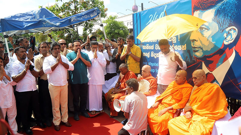 Opposition politicians, Buddhist clergy and supporters take part in the launch of a Satyagraha campaign in front of Fort Railway Station on June 8, 2026, in support of detained former intelligence chief Suresh Sallay