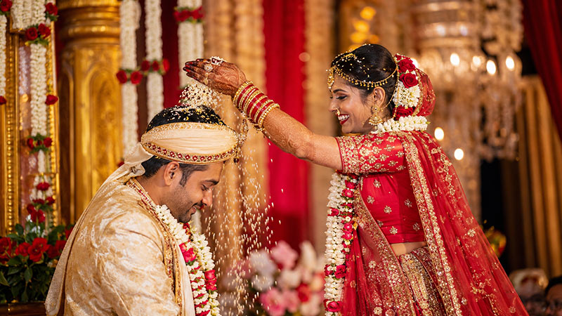 Indian bride performing a traditional wedding ritual with the groom at a luxury wedding venue