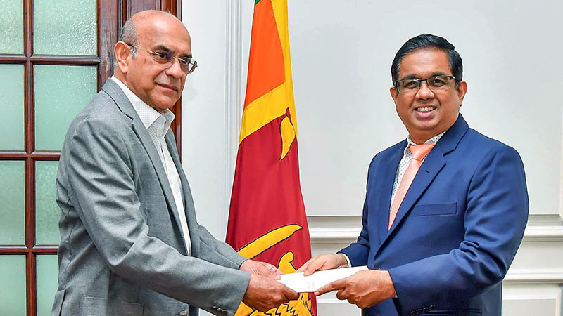 Retired Supreme Court Judge Priyantha Fernando receiving his appointment document from Secretary to the President Dr. Nandika Sanath Kumanayake
