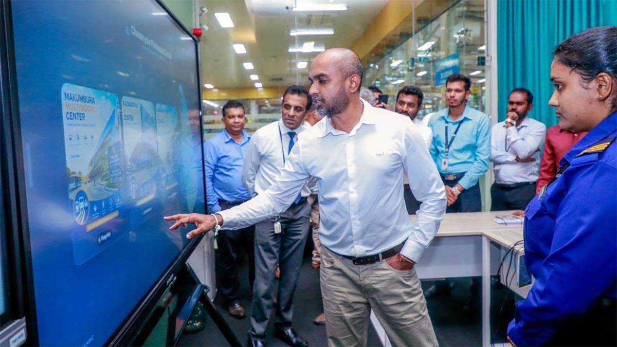 Deputy Minister Prasanna Gunasena browsing the newly launched multimodal transport website on a touchscreen display