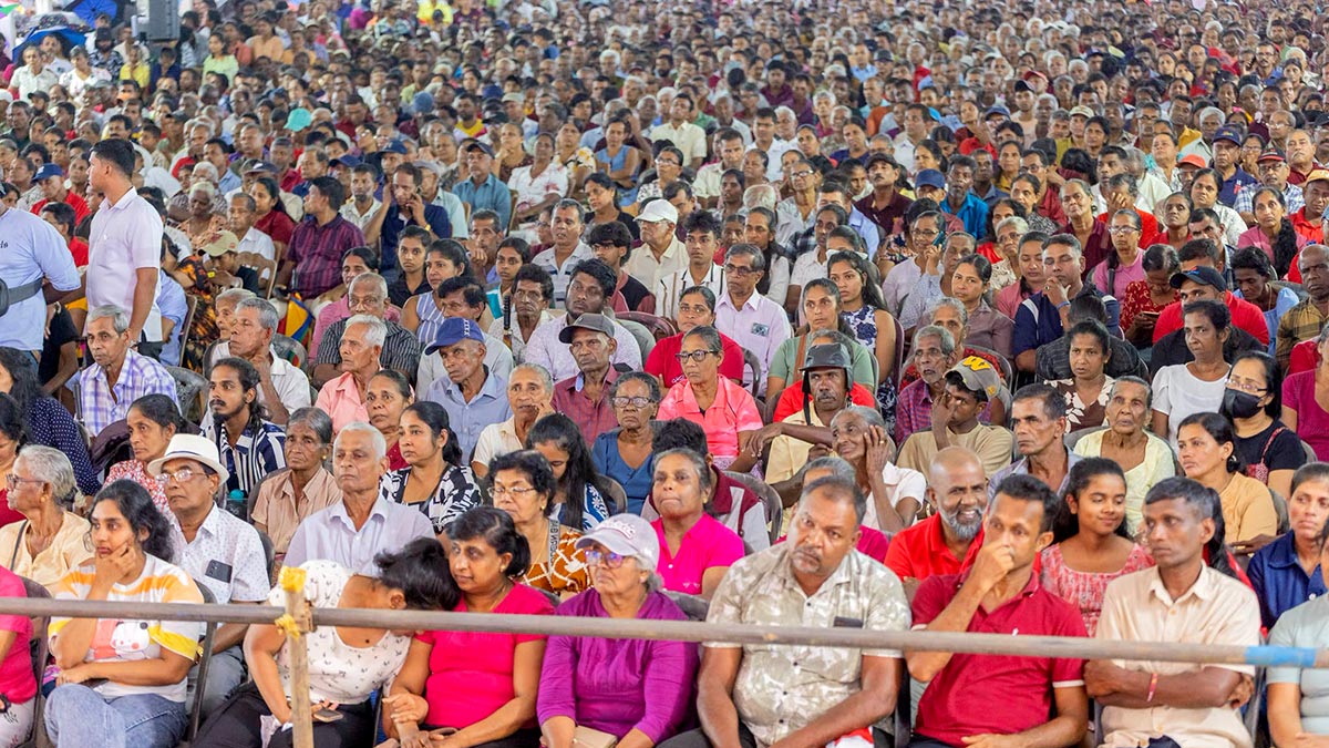 A large crowd listening near the stage at the Akuressa public rally on September 20, 2026