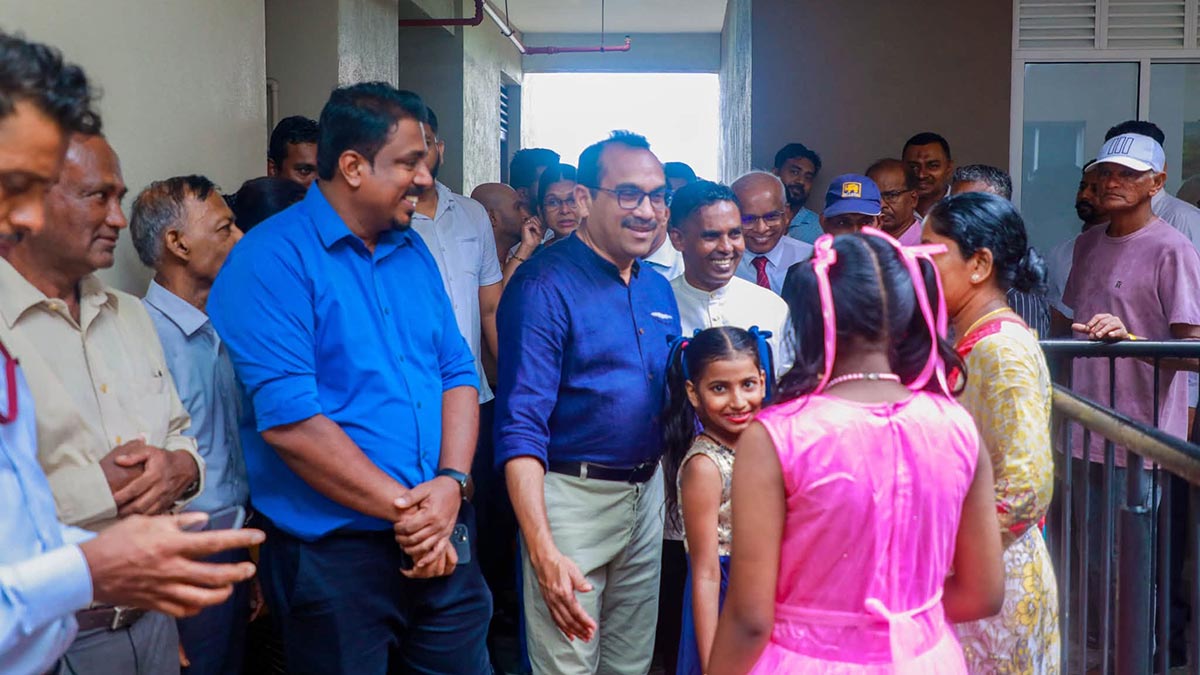 Minister Bimal Rathnayake speaks with residents inside the Port View Residencies apartment complex in Grandpass, Colombo