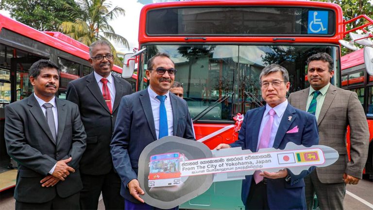 Japan Ambassador Akio Isomata hands over a symbolic key for donated low-floor buses to Minister Bimal Rathnayake