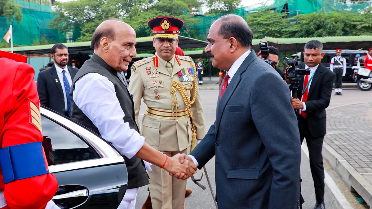 Indian Defence Minister Rajnath Singh shakes hands with Deputy Defence Minister Major General Aruna Jayasekara after arriving at the Defence Headquarters Complex in Kotte