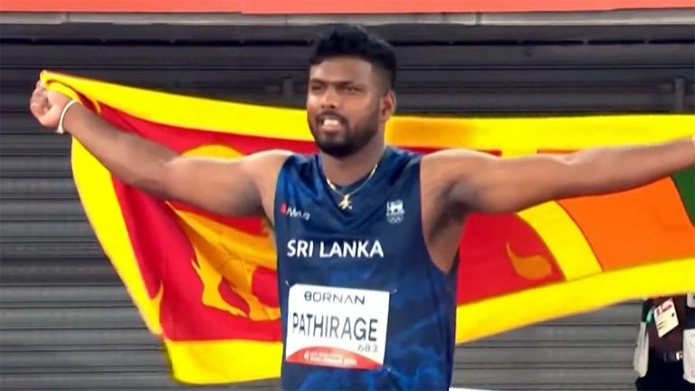 Rumesh Tharanga holds the Sri Lanka flag after winning the men’s javelin throw gold medal at the 2026 Asian Games in Aichi-Nagoya, Japan