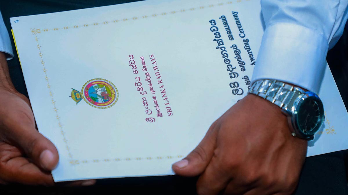 New Sri Lanka Railways Engine Driver Assistant holding an appointment letter at the appointment ceremony