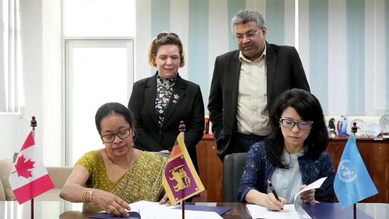 UNDP Resident Representative Azusa Kubota and Acting Government Analyst Kamani Perera sign agreements as Minister Harshana Nanayakkara and Canadian High Commissioner Isabelle Martin look on