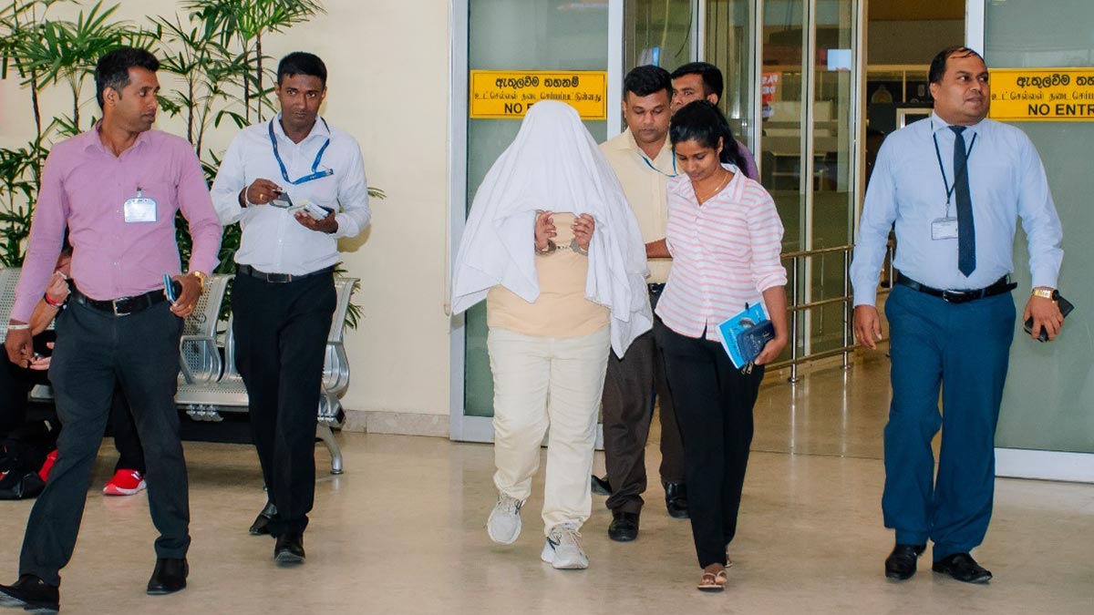 Anusha Lakmali, alias ‘Achini’, escorted by police at Bandaranaike International Airport in Katunayake, Sri Lanka