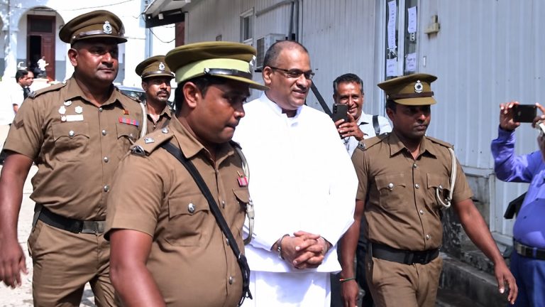 Venerable Galagoda Aththe Gnanasara Thera wearing white prison attire