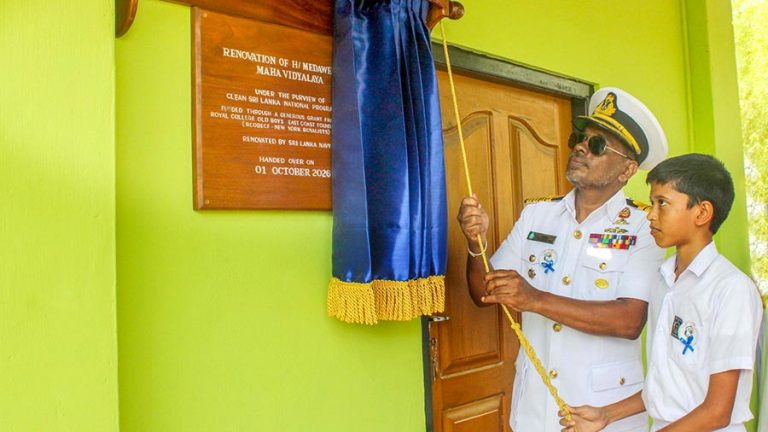 Sri Lanka Navy Captain Senaka Premaratne and a student unveil a commemorative plaque at Medawelana Maha Vidyalaya in Tissamaharama