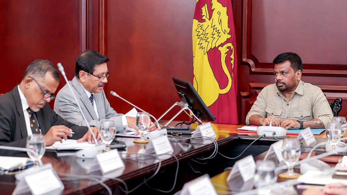 Central Bank Governor Dr P. Nandalal Weerasinghe speaks as President Anura Kumara Dissanayake listens during the AML/CFT meeting