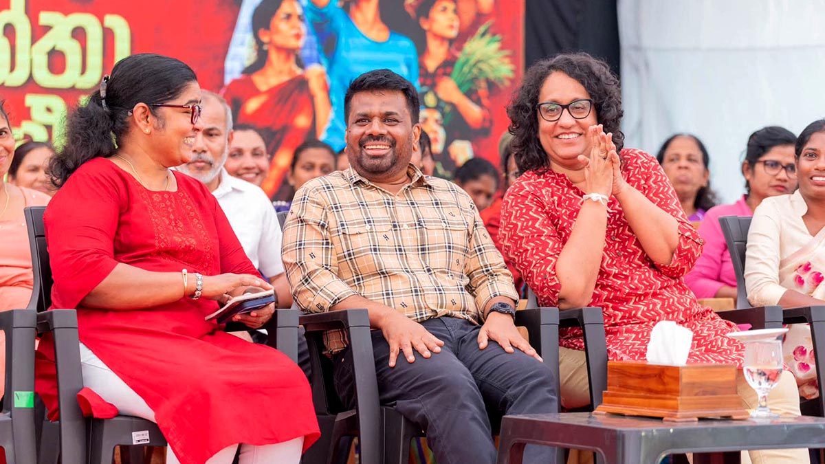 President Anura Kumara Dissanayake, Prime Minister Harini Amarasuriya and Minister Saroja Savithri Paulraj share a friendly conversation while seated on stage at the Badulla District Women's Conference