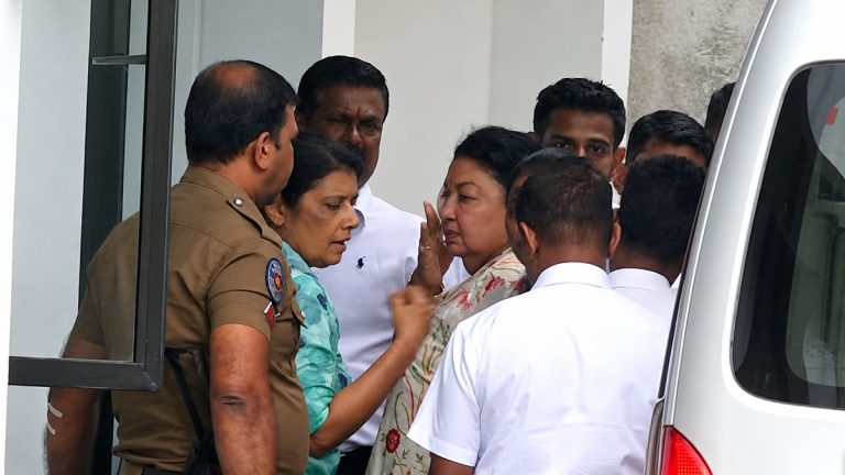 Shiranthi Rajapaksa steps out of a white van upon arrival at the CIABOC office in Colombo