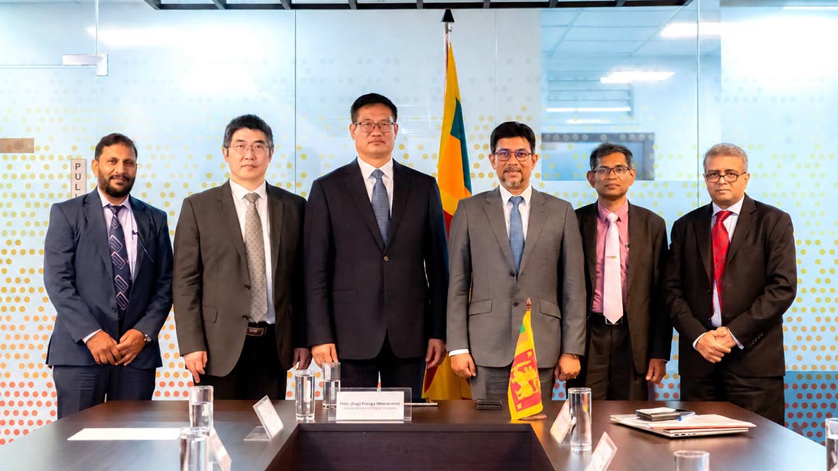 Sri Lanka's Deputy Minister of Digital Economy Eranga Weeraratne, Chinese Ambassador Wei Huaxiang, Chief Presidential Adviser on the Digital Economy Dr. Hans Wijayasuriya, and other officials pose for a group photograph following a meeting in Colombo on October 14, 2026